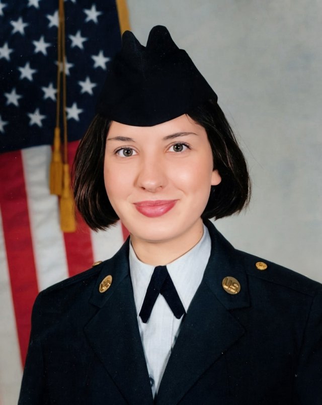 Andrea Rose Baker in Army dress uniform in front of a U.S. flag